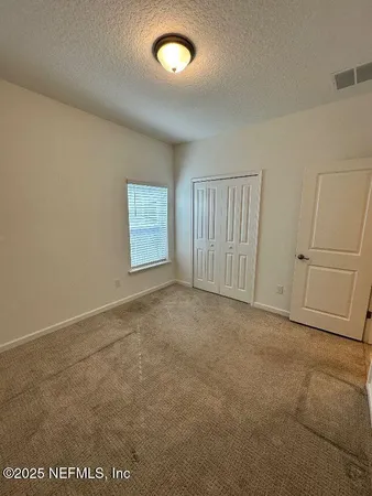 an empty room with a empty space and windows