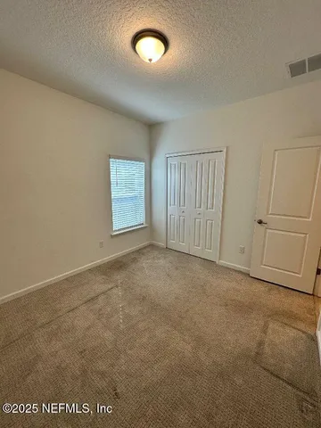 an empty room with a empty space and windows