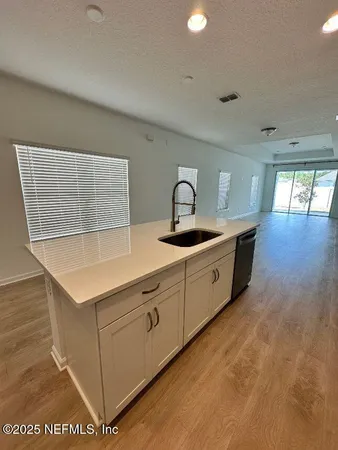 a kitchen with stainless steel appliances granite countertop a sink and a stove
