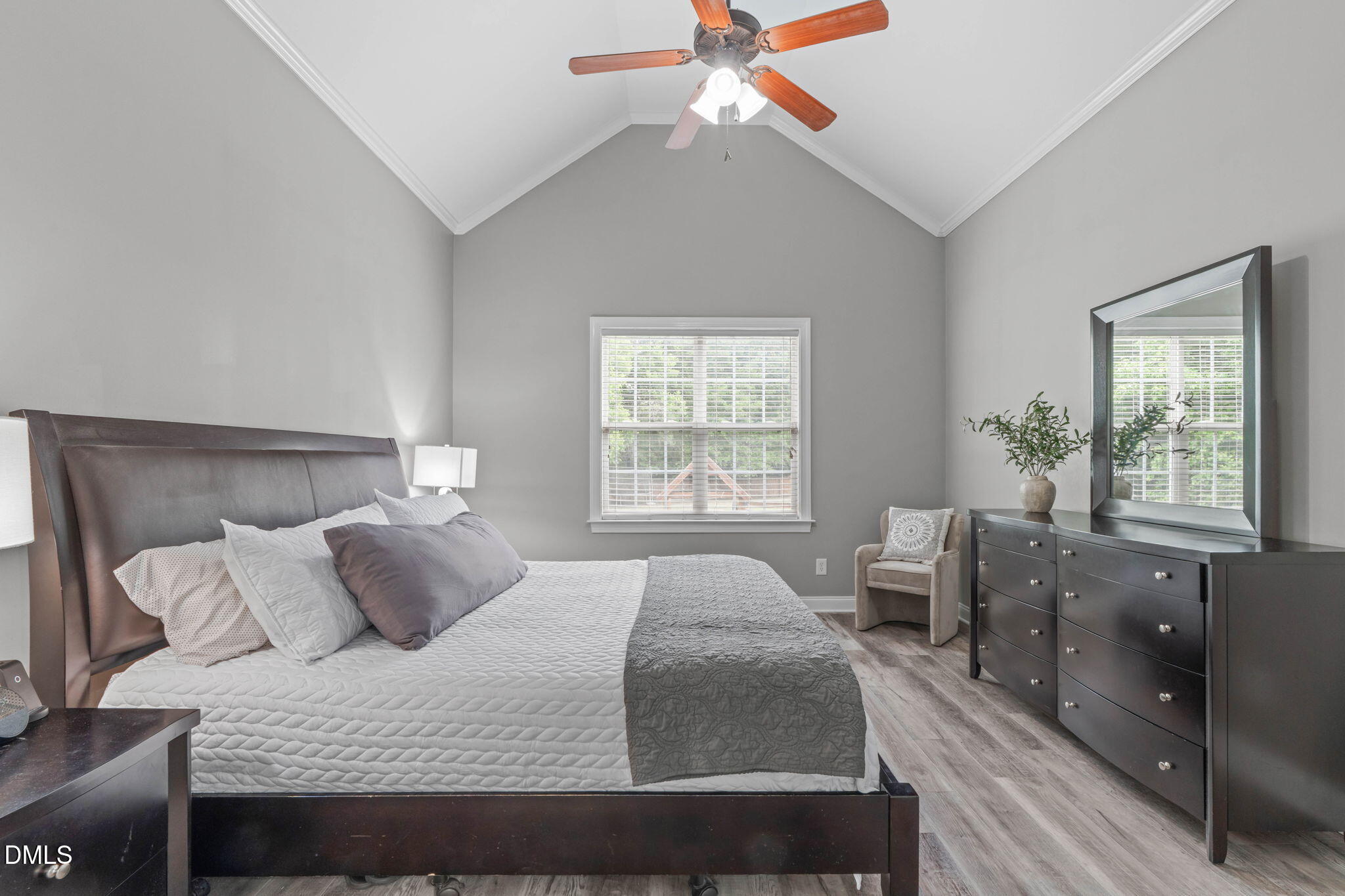 2450 Rolling Tracks Road Willow Spring, NC 27592 - Photo 30 of 64 a bedroom with a large bed and a window
