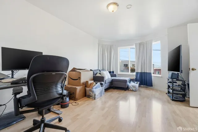 a livingroom with workspace and a couch