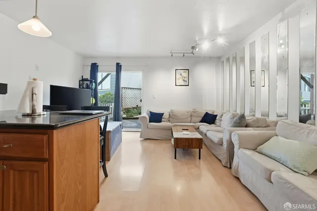 a living room with furniture a flat screen tv and a window