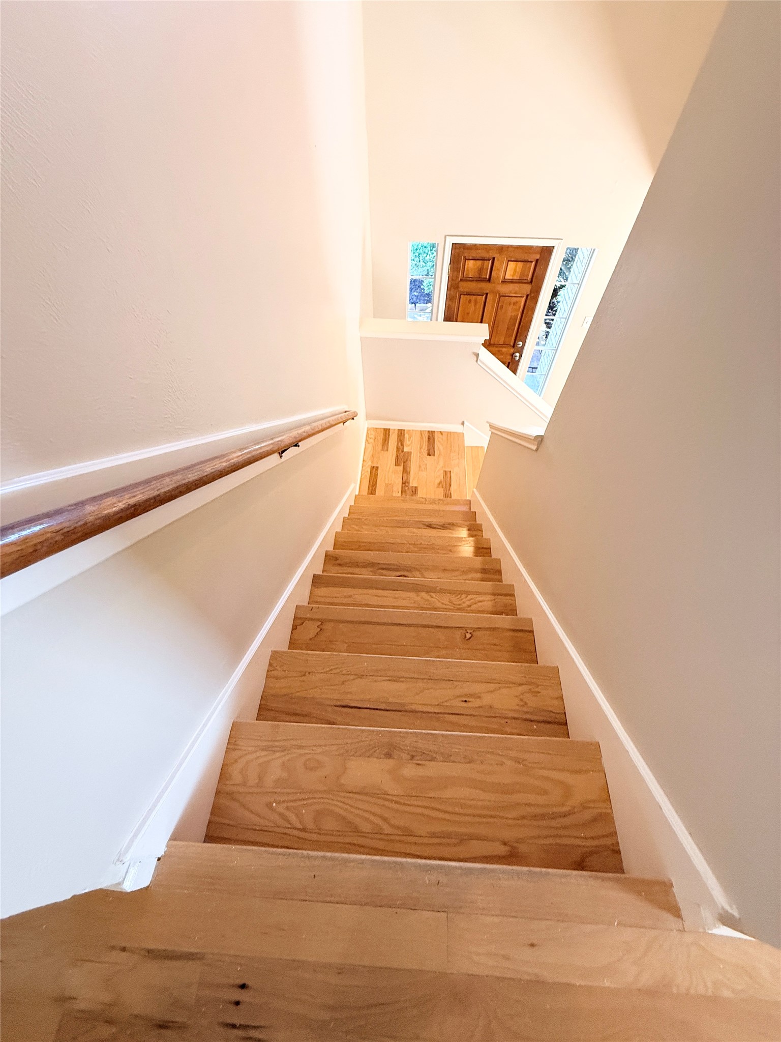 245 North Ranch House Road Angleton, TX 77515 - Photo 9 of 19 This staircase is warm and inviting, featuring natural wood steps and a clean, bright surrounding that really lets the light flow in.