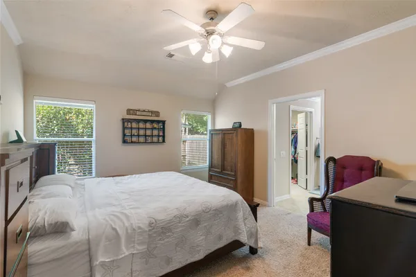 a bedroom with a bed dresser and a window