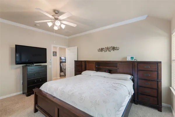 a bedroom with a large bed and a flat screen tv