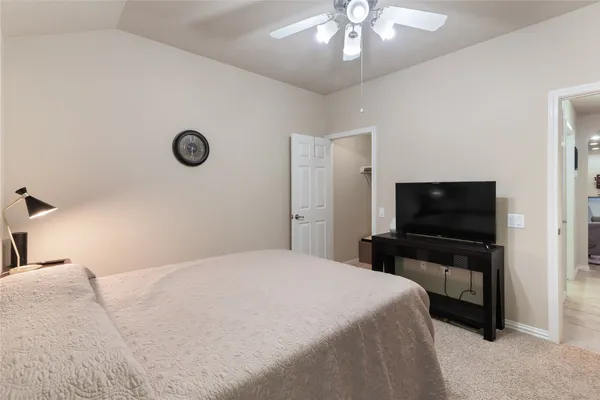 a bedroom with a bed and a flat screen tv