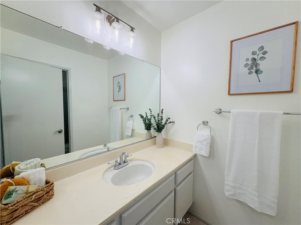1044 Kent San Dimas, CA 91773 - Photo 8 of 16 a bathroom with a granite countertop sink and a mirror