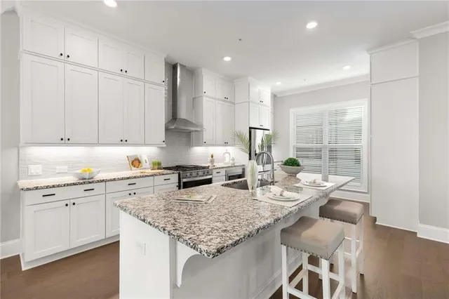 a kitchen with granite countertop kitchen island white cabinets and appliances