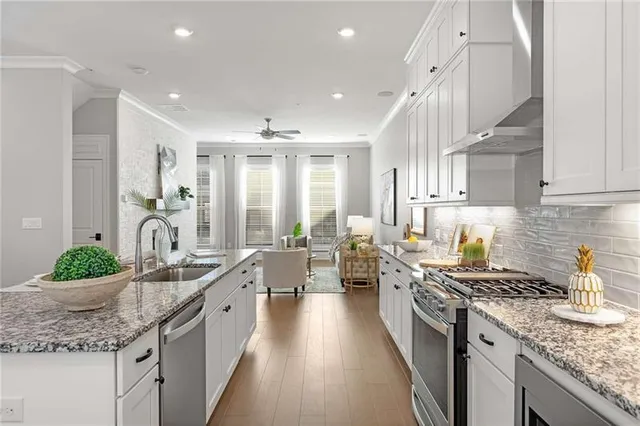 a large kitchen with kitchen island lots of counter space a sink and stainless steel appliances