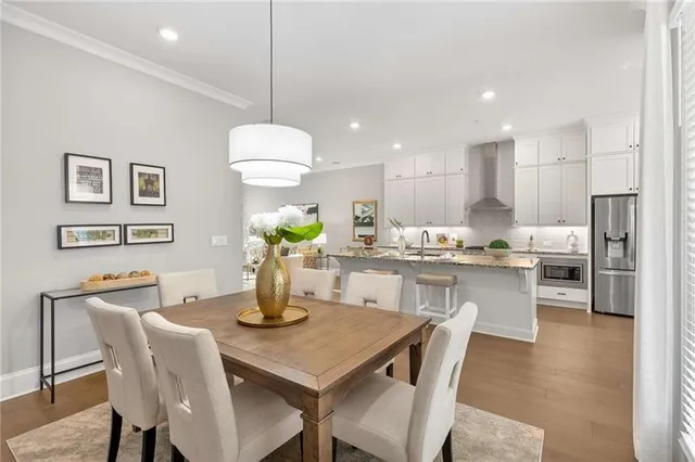 a kitchen with a dining table chairs and view living room