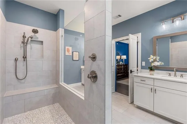 a bathroom with a shower sink and mirror