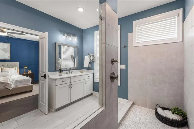 a spacious bathroom with a granite countertop sink and a mirror