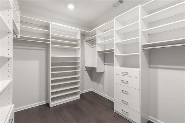 a view of walk in closet with empty racks