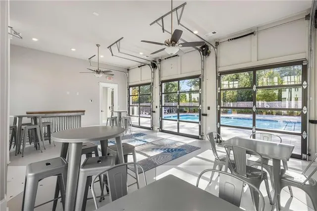 a view of a dining room with furniture large windows and wooden floor