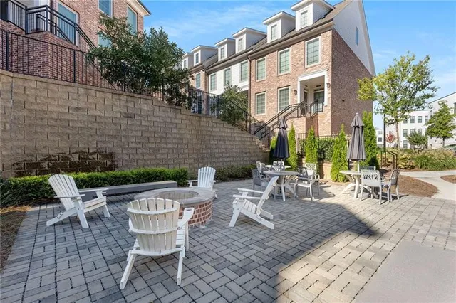 a view of backyard with outdoor seating and plants