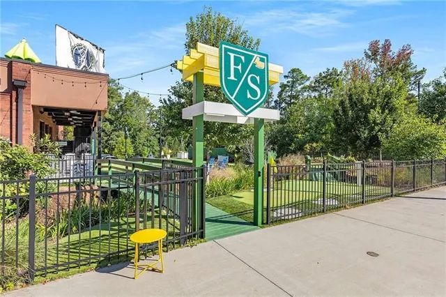 a view of a park with iron fence