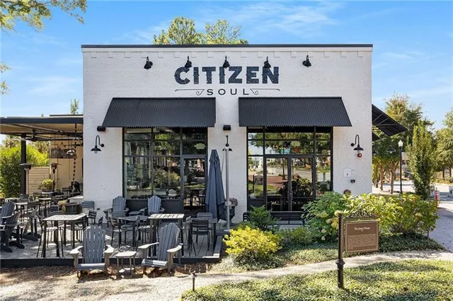 a front view of a building with outdoor seating