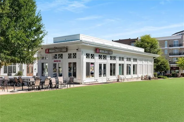 a front view of a house with a yard table and chairs