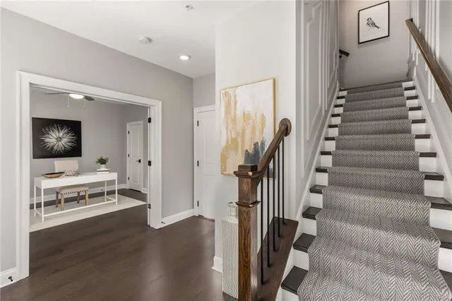 a view of a livingroom with wooden floor and stairs