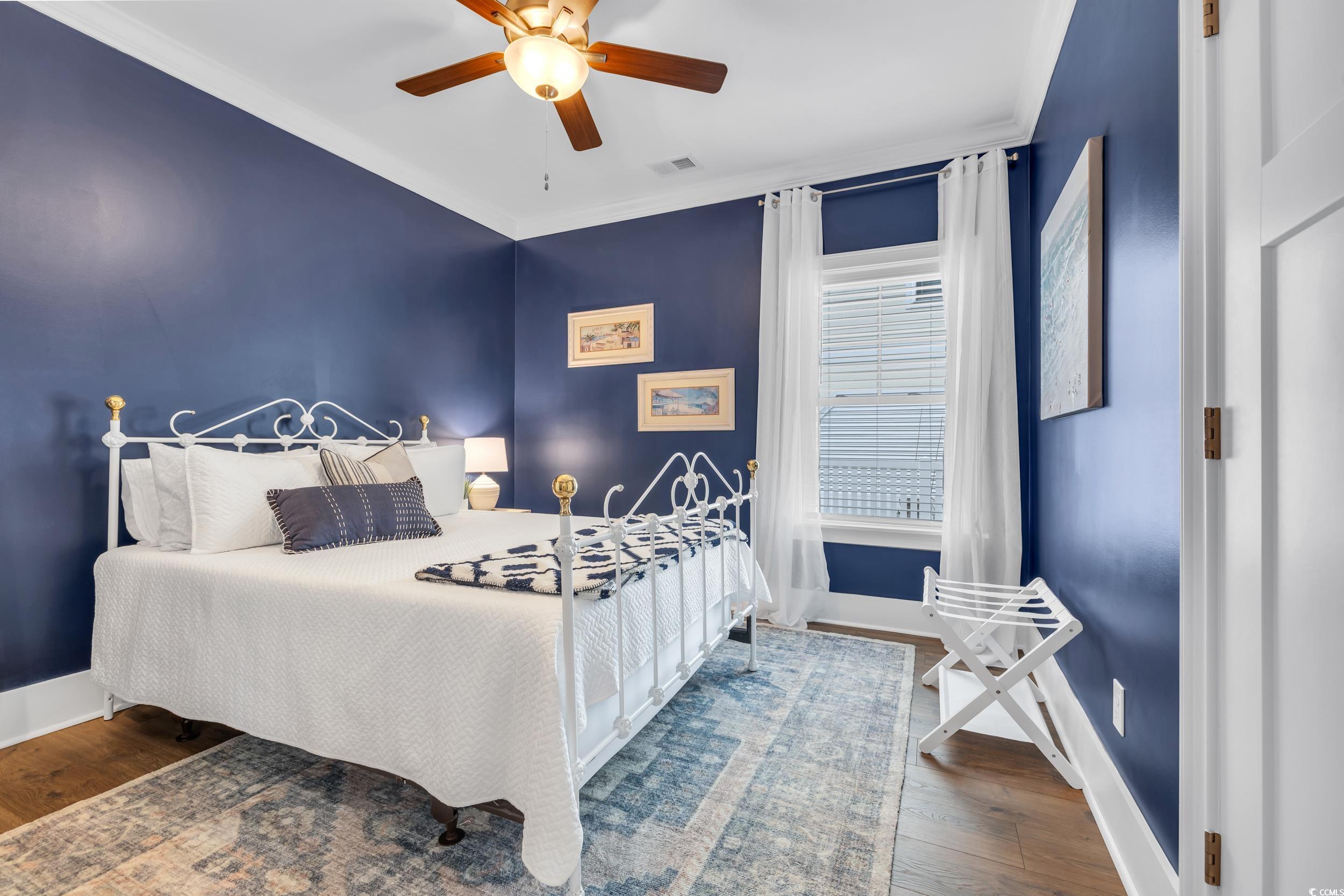 22 Trigger Fish Lane Murrells Inlet, SC 29576 - Photo 31 of 39 Bedroom with crown molding, ceiling fan, and dark