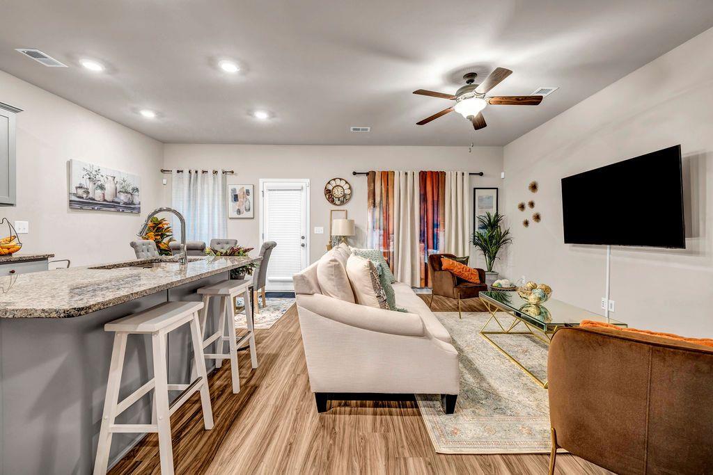 255 Skipjack Court Covington, GA 30016 - Photo 11 of 24 a living room with fireplace furniture and a flat screen tv