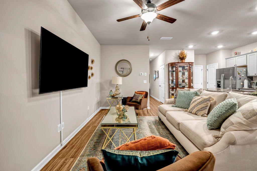 255 Skipjack Court Covington, GA 30016 - Photo 12 of 24 a living room with furniture and a flat screen tv