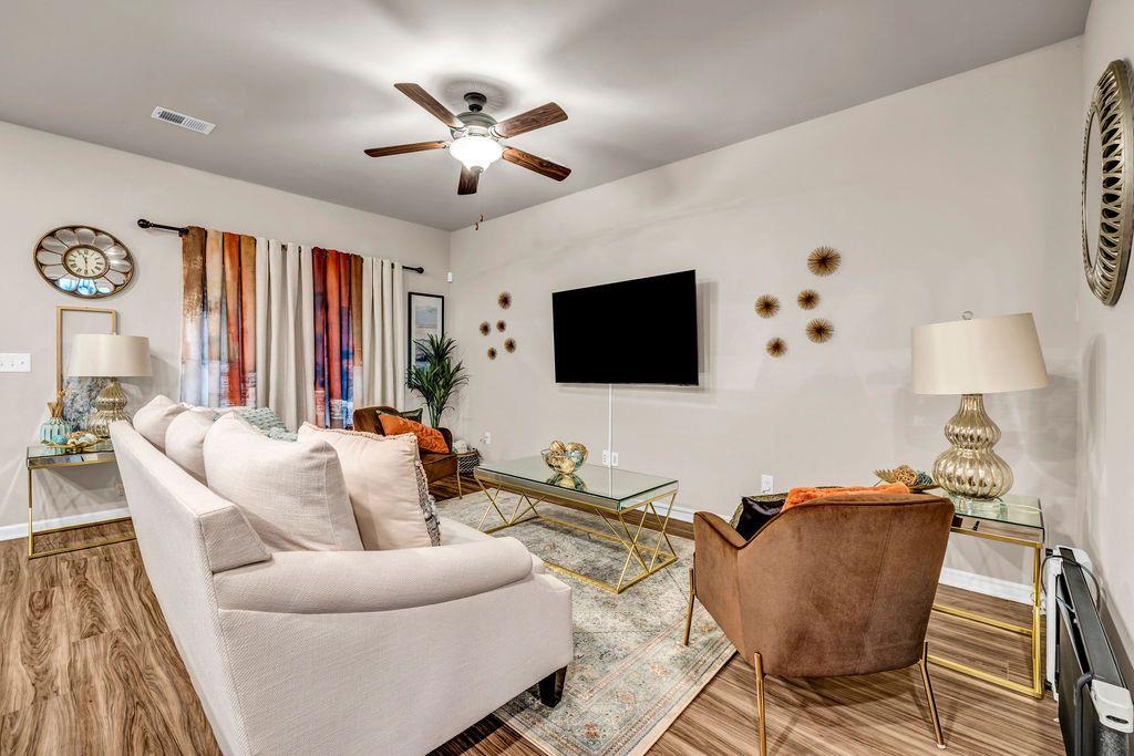 255 Skipjack Court Covington, GA 30016 - Photo 14 of 24 a living room with furniture and a flat screen tv