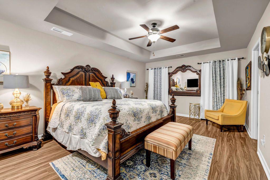 255 Skipjack Court Covington, GA 30016 - Photo 17 of 24 a bedroom with a bed and a chandelier