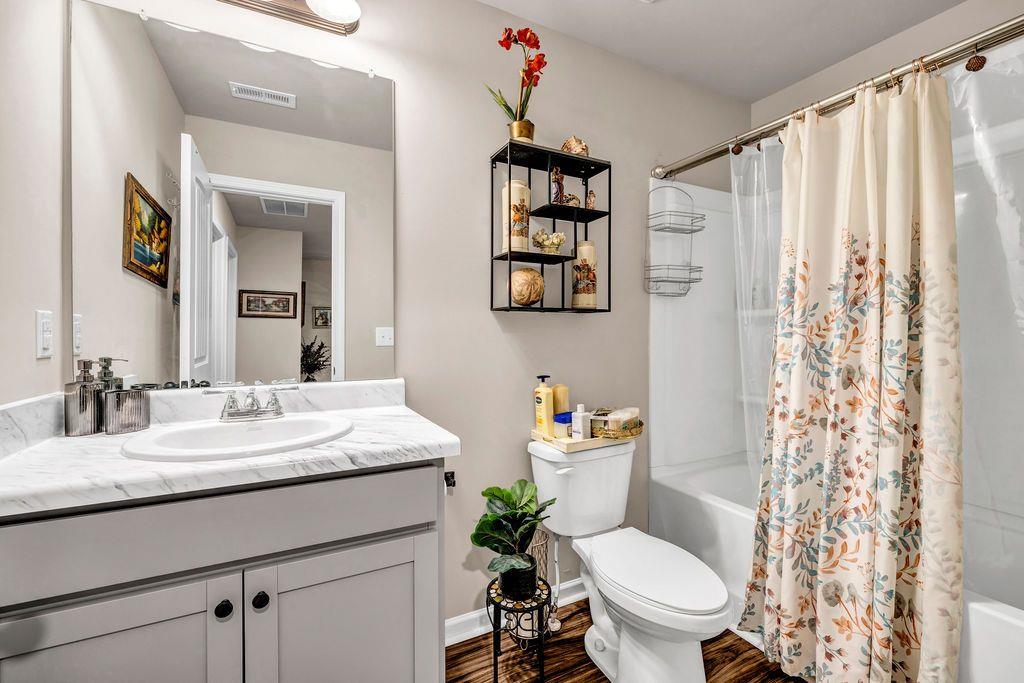 255 Skipjack Court Covington, GA 30016 - Photo 18 of 24 a bathroom with a granite countertop sink mirror vanity and toilet