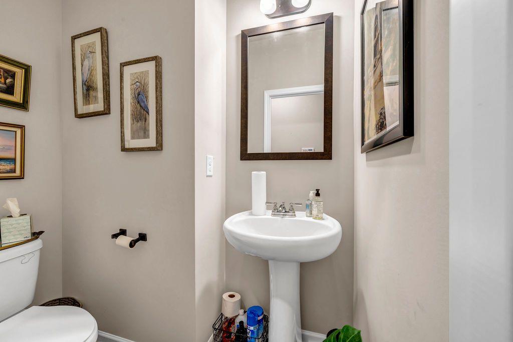 255 Skipjack Court Covington, GA 30016 - Photo 21 of 24 a bathroom with a sink toilet and mirror