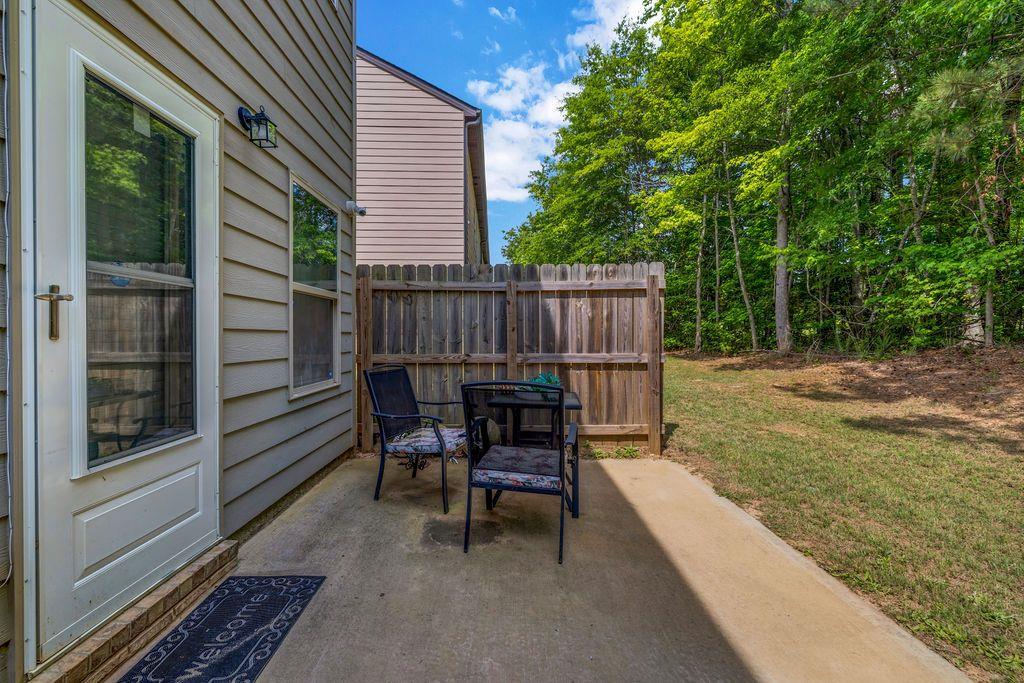 255 Skipjack Court Covington, GA 30016 - Photo 24 of 24 a view of a chairs and tables in the back yard of the house