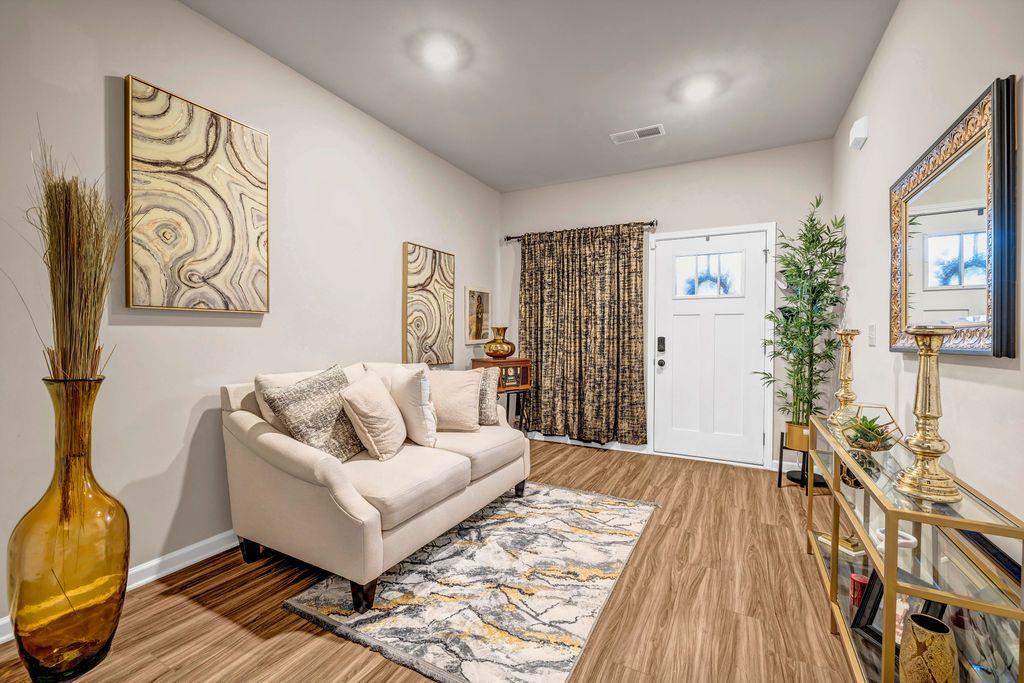 255 Skipjack Court Covington, GA 30016 - Photo 5 of 24 a living room with furniture and wooden floor