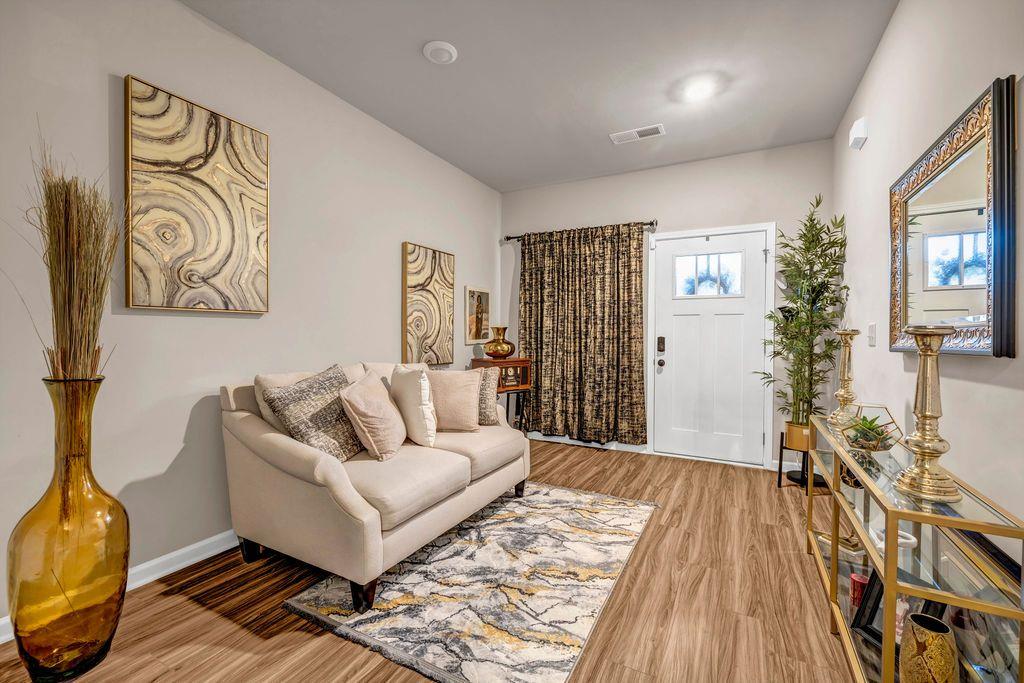 255 Skipjack Court Covington, GA 30016 - Photo 6 of 24 a living room with furniture and wooden floor