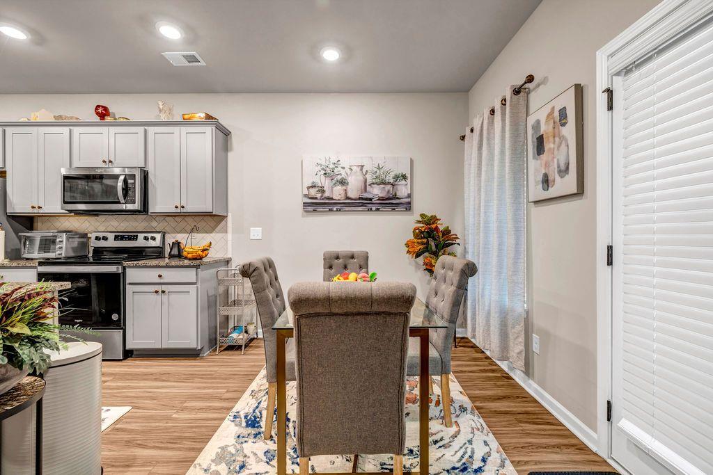255 Skipjack Court Covington, GA 30016 - Photo 10 of 24 a kitchen with stainless steel appliances granite countertop a stove a refrigerator and a microwave