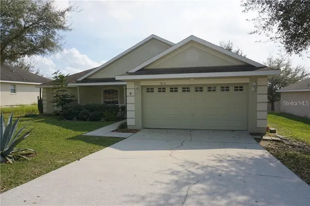 a front view of a house with a garden and yard