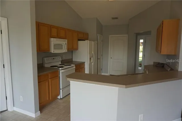 a kitchen with a refrigerator and a sink