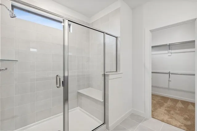 a bathroom with a glass shower door