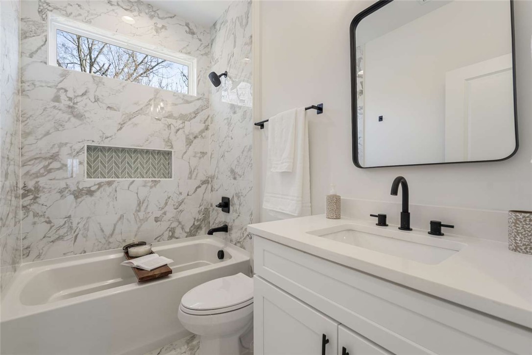 191 Murdock Road Belton, SC 29627 - Photo 18 of 24 This bathroom features elegant marble-look tiling and modern fixtures.