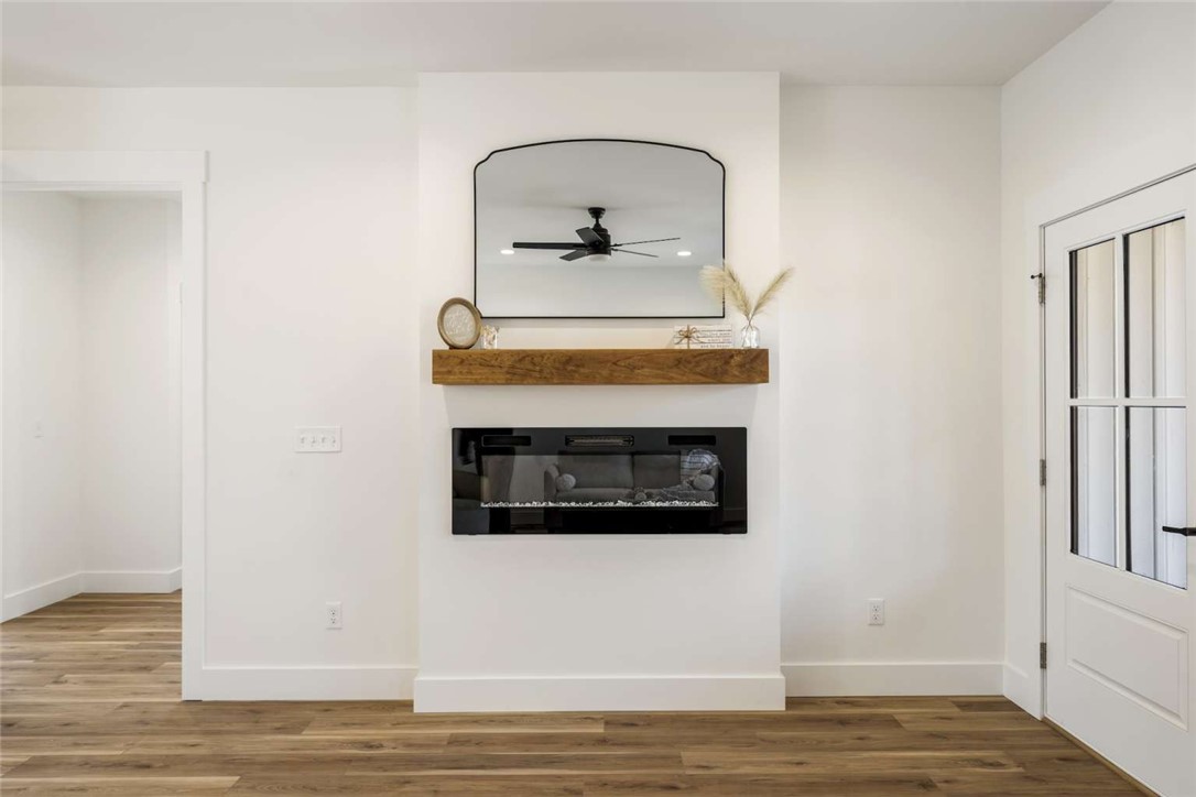 191 Murdock Road Belton, SC 29627 - Photo 6 of 24 This inviting space features an elegant fireplace with a natural wood mantel and warm flooring.
