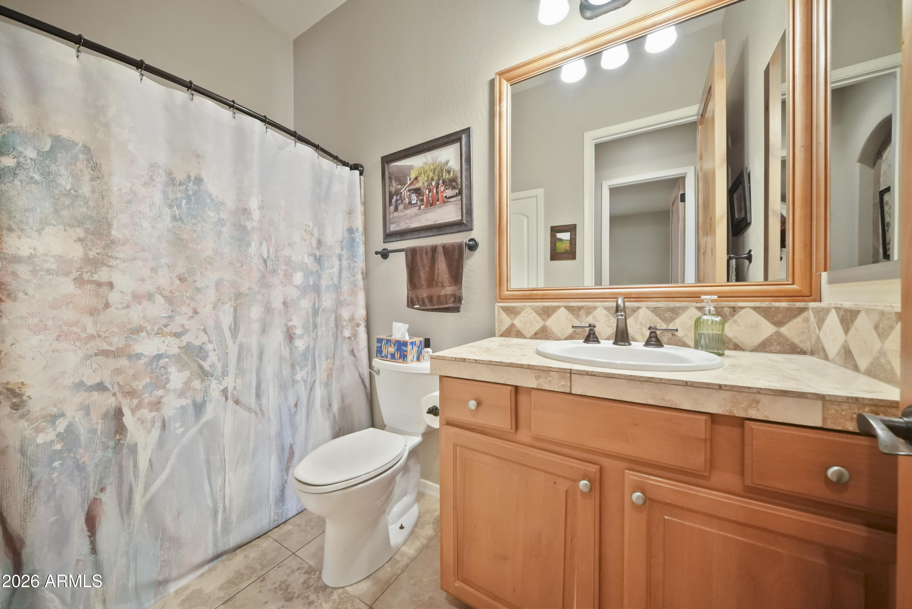 605 West Ridgecrest Road Phoenix, AZ 85086 - Photo 31 of 40 a bathroom with a granite countertop sink a toilet and a mirror