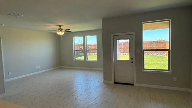 a kitchen with kitchen island granite countertop a sink stove and refrigerator