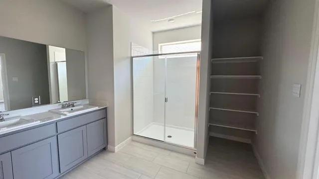 an empty room with windows and closet