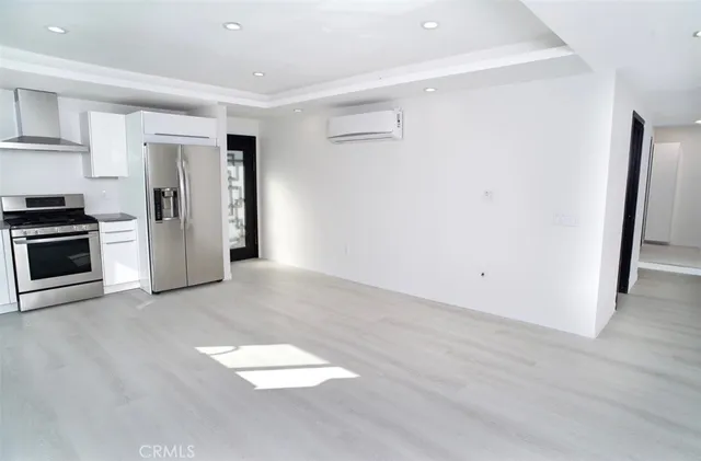 a view of a kitchen with refrigerator and an oven
