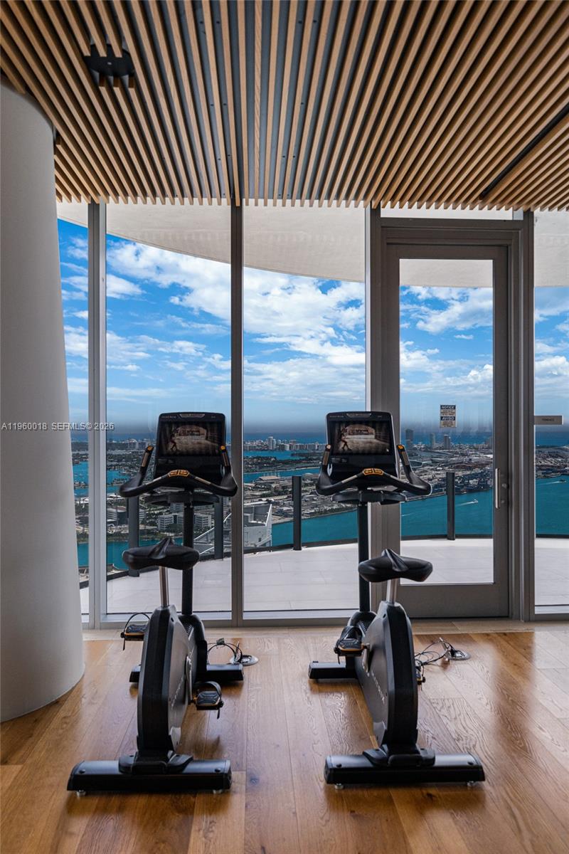 300 Biscayne Blvd Way, Unit 2009 Miami, FL 33131 - Photo 44 of 58 a room with gym equipment and a large window