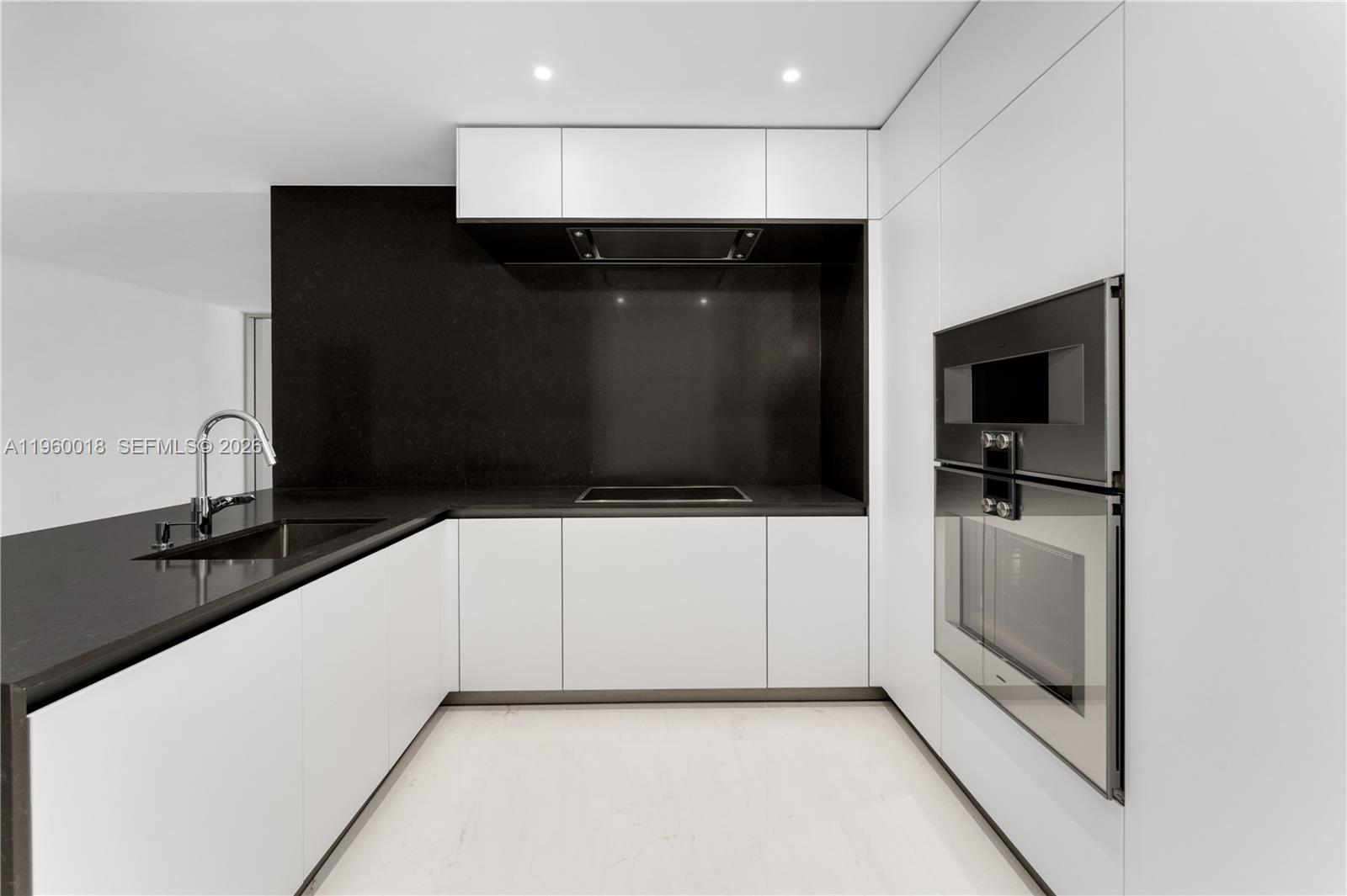 300 Biscayne Blvd Way, Unit 2009 Miami, FL 33131 - Photo 6 of 58 a kitchen with a sink and white cabinets