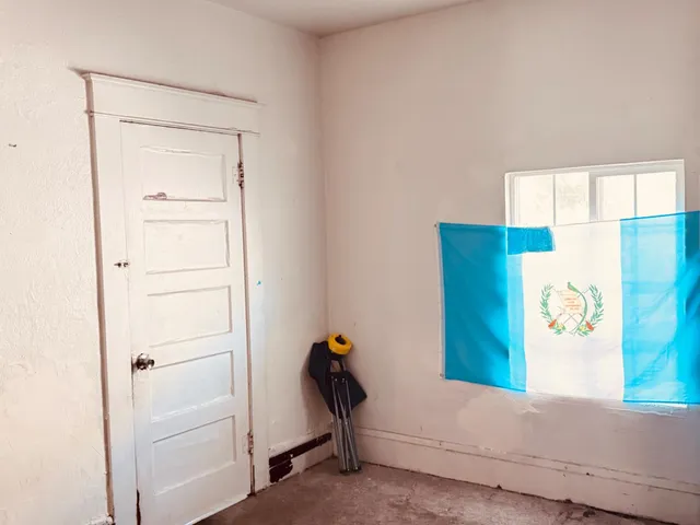 a view of hallway with closet and a window