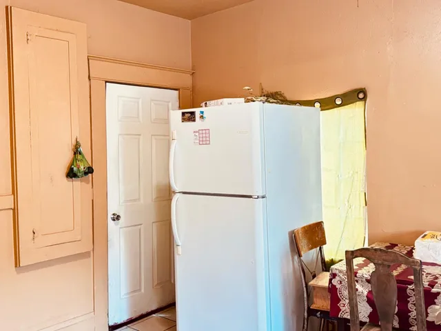 a white refrigerator freezer sitting next to a window