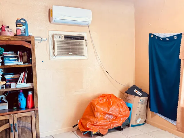 a living room with wooden floor and book shelf