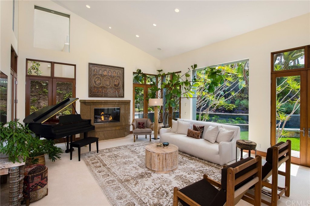10 Smithcliffs Road Laguna Beach, CA 92651 - Photo 11 of 38 a living room with furniture fireplace and large windows