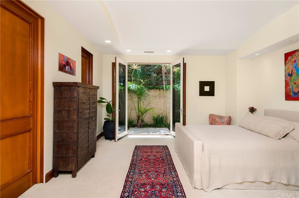 10 Smithcliffs Road Laguna Beach, CA 92651 - Photo 19 of 38 a bedroom with a bed and a wooden floor